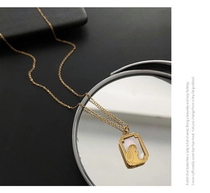 Macro view of golden rabbit moonstone pendant with mother of pearl inlay on mirror surface