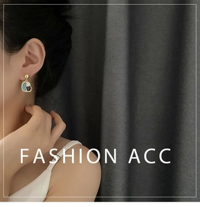 Model wearing vintage-style color-block pendant earrings with gold alloy and colorful enamel