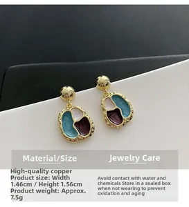 Detail of colorful geometric enamel earrings with copper frame showing dimensions and texture