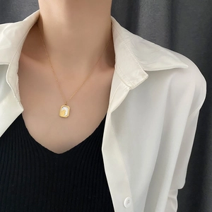 Exquisite gold moon rabbit necklace with white shell pendant on a female model