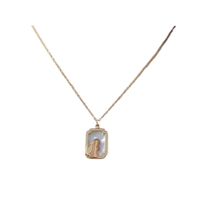 Elegant gold titanium necklace with a rabbit relief on a white mother-of-pearl pendant