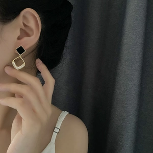 Elegant gold hollow square earrings with black geometric studs and sparkling zircon stones
