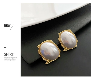 Close-up of French luxury pearl earrings with irregular gold vintage metallic frames