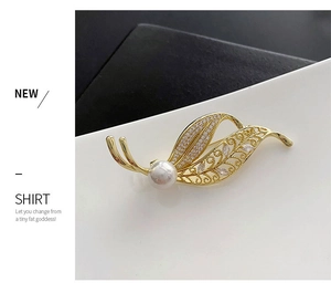 Detailed view of leaf brooch with pearl and zircons on black and white background