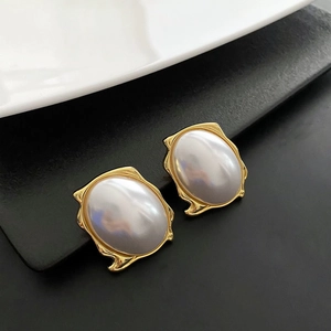 French retro gold earrings with irregular metal frames and large white oval pearls
