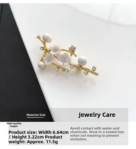 Detailed view of natural shell plum blossom brooch with pearls and copper branches
