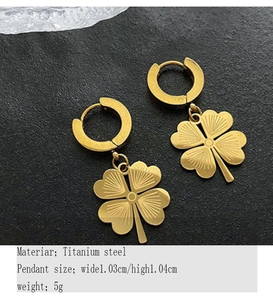 Detail of gold titanium steel four-leaf clover hoop earrings with radial texture detail