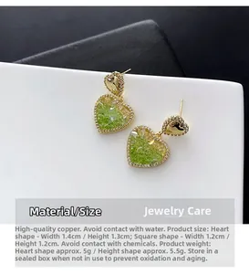 Detailed view of heart-shaped gold studs with green crystals and micro-pave cubic zirconia