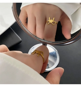 Detailed view of a gold titanium ring featuring a minimalist hollow rabbit ear design