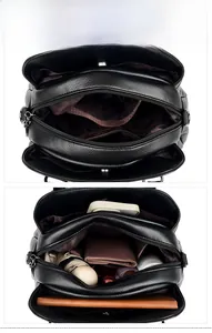 Vista interna di una borsa in pelle nera con tre ampi scomparti per l'organizzazione