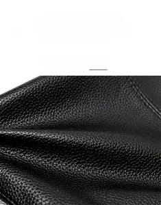 Macro view of premium black lychee pattern leather texture with soft luster finish
