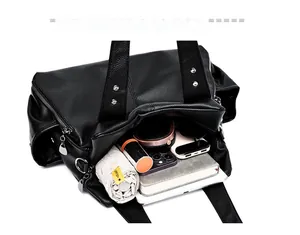 Top view of black pebbled leather tote showing spacious interior for tablet and umbrella