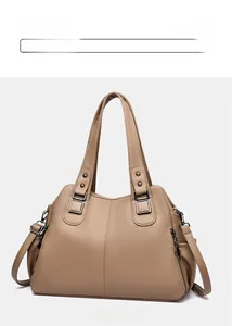 Detail view of khaki faux leather tote bag showing lychee grain texture and silver hardware