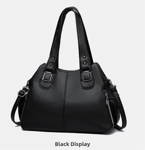 Detailed side view of black pebbled leather tote with silver zippers and hardware
