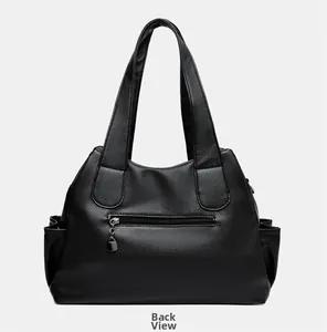Back view of black faux leather tote bag with functional zipper pocket and side pockets