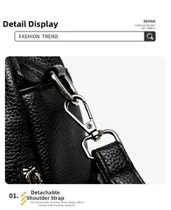 Detail of black pebbled leather texture with silver metal hook and detachable strap