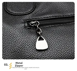Close-up of high-quality silver metal zipper on black lychee grain leather tote bag