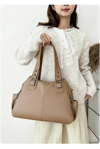 Brown lychee leather tote bag with sturdy double handles and side zipper details