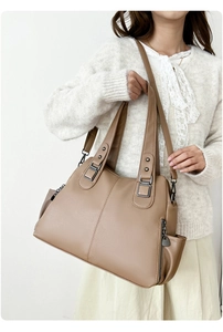 Close-up of brown litchi pattern leather tote bag with side zippers and adjustable strap