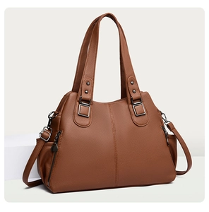 Detailed view of dark brown pebbled leather tote with gunmetal hardware and dual handles