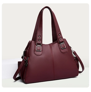 Detail of wine red tote bag with lychee grain texture and adjustable shoulder strap