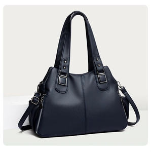 Detail view of large navy blue tote bag with pebble texture and silver zipper accents