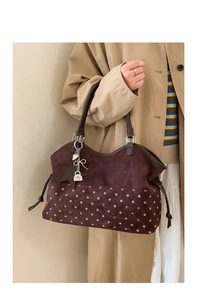 Detail of vintage brown tote bag featuring Moon Shark embroidery and star padlock charms