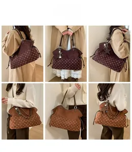 Detail of burgundy and tan tote bags with polka dots and star charm accessory