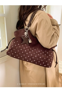 Detailed texture of dark coffee suede tote with white dots and Mvon Shark embroidery