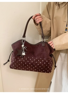 Detail of burgundy suede tote bag with white polka dots and Meon Shark embroidery