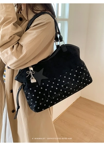 Detail of black suede tote bag featuring white polka dots and Moon Shark printed logo