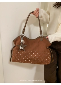 Detail of brown matte tote bag with white polka dots, Moon Shark embroidery and star charm