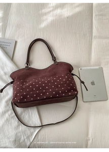 Detail of burgundy polka dot tote bag with Moon Shark embroidery and leather straps