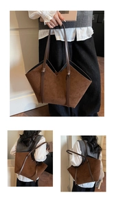 Detail view of large brown suede tote bag with V-cut opening and long shoulder handles