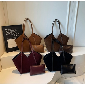 Detail view of large suede tote bags with matching leather pouches in four classic colors