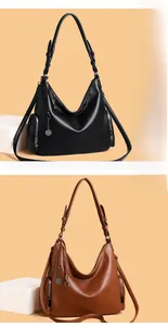 Detail view of black and brown vintage hobo bags with side zippers and metal charms