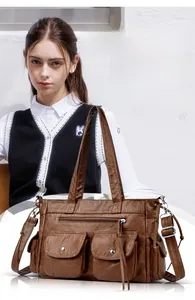 Détail du sac à main marron en cuir PU rétro avec des poches et des fermetures éclair