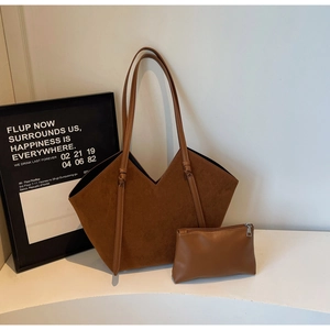 Brown faux suede tote bag and matching zipper pouch set shown against a minimalist wall