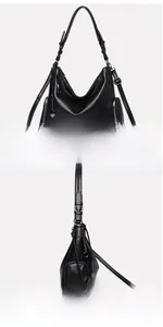 Detail view of black pebble textured shoulder bag with side zipper and metal ring