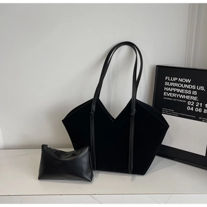 Detail of minimalist black tote bag set with knotted handle and matching zipper pouch