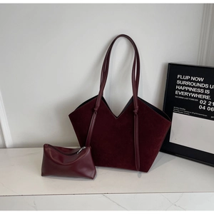 Detail of burgundy vintage tote set with matte texture and decorative knot handle