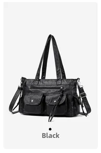 Détail du sac cabas noir à poches multiples avec zips argentés et boutons pression