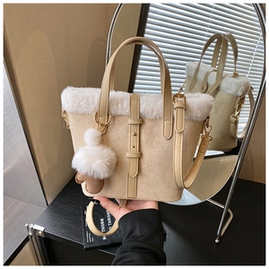 Detail of suede bucket bag with white faux fur trim and plush ice cream charm pendant