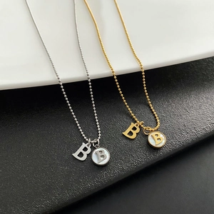 Titanium steel letter B necklaces in gold and silver with white shell pendant detailing