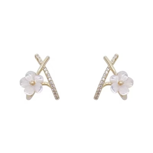 Elegant gold-tone crisscross hoop earrings with white floral accent and sparkling zircon stones