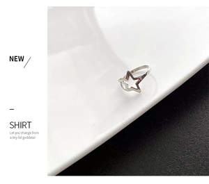 Close-up of a silver hollow star ring made of titanium steel with a polished finish