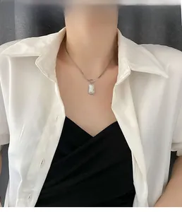 Detail of silver titanium blade chain necklace featuring a rectangular mother of pearl pendant