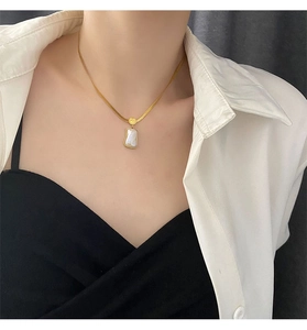 Detail of 18K gold blade chain necklace with rectangular mother of pearl pendant