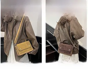 Detail showing vintage yellow and dark brown square bags used as shoulder or crossbody bag
