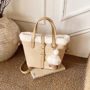 Minimalist beige frosted fleece bucket bag with plush trim and cute pompom charm